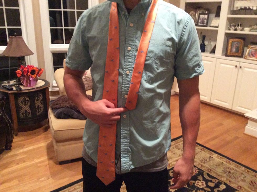 Place the skinny end of the tie right above your belly button