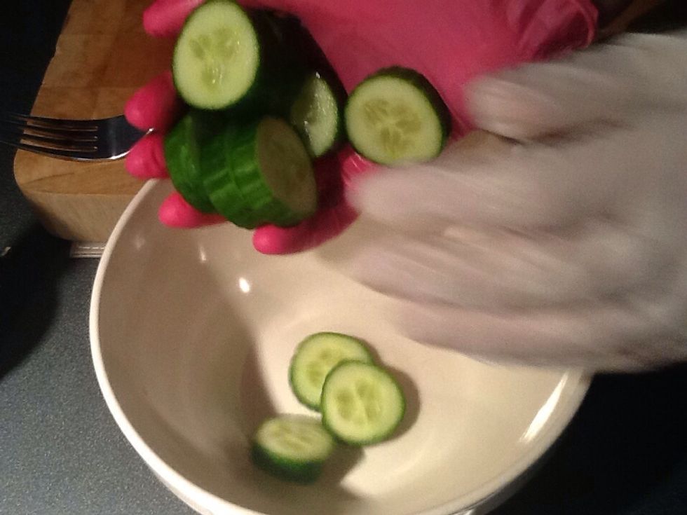 Place the sliced cucumber in the bowl