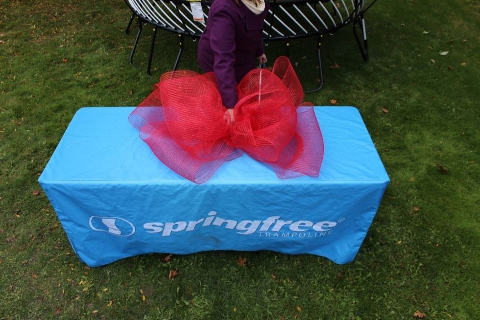 Place the smaller bow on top of and in the center of the larger bow.  Secure them together with wire