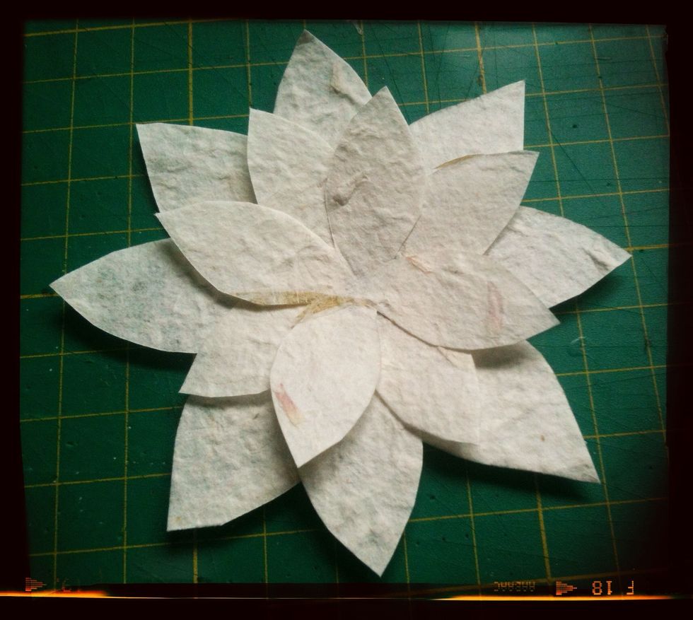 Place the smaller flower on top of the big one, rotate the small flower until you are happy with the positioning and then glue. Now leave to dry for a little while.