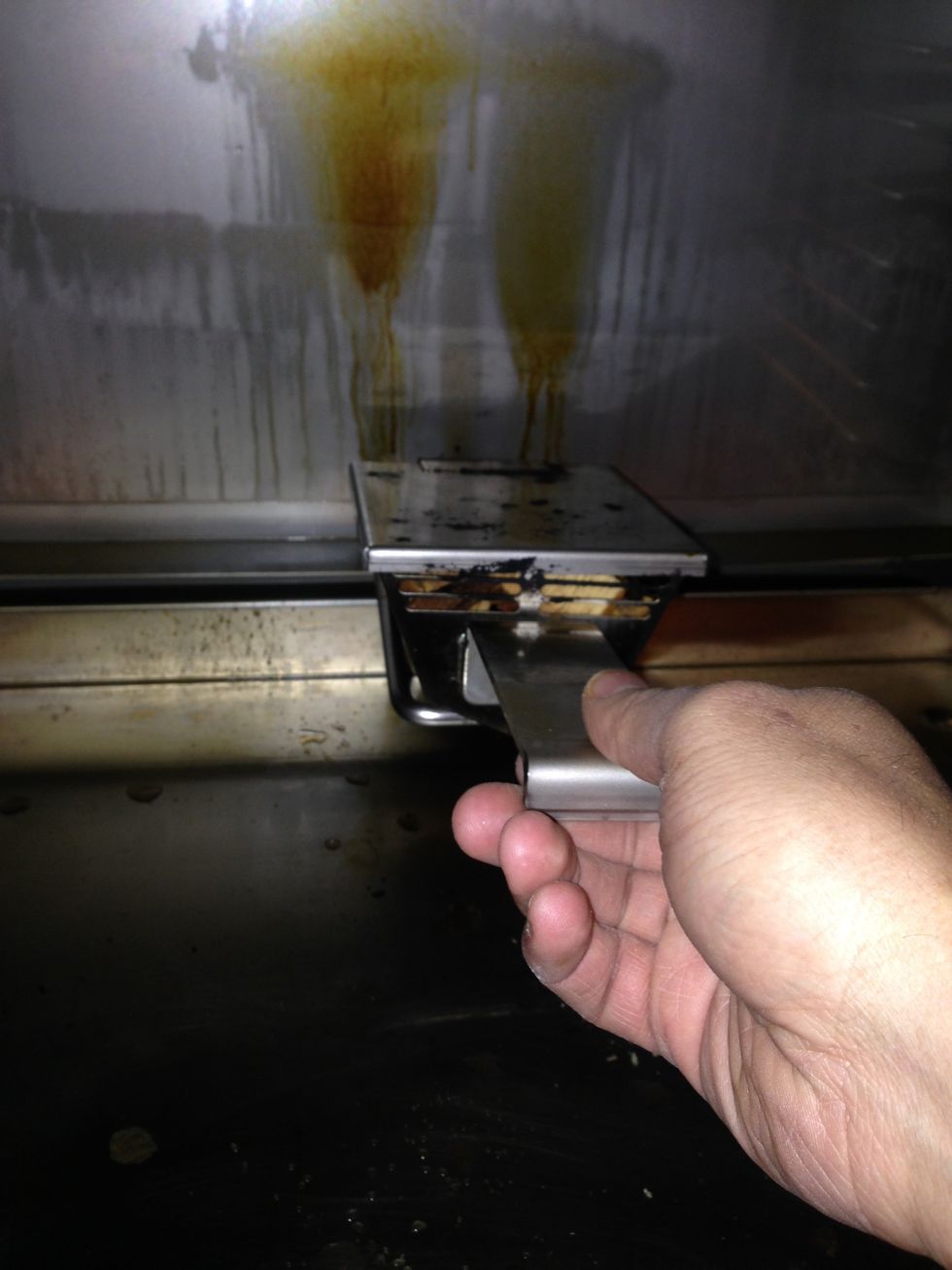 Place the smoker box into the oven like this. Be careful, as the interior of the oven will be hot.