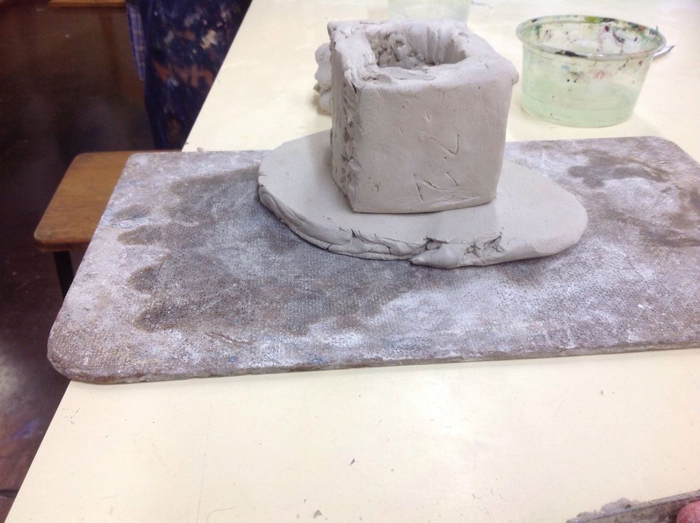 Place the sort of cube on top of the clay