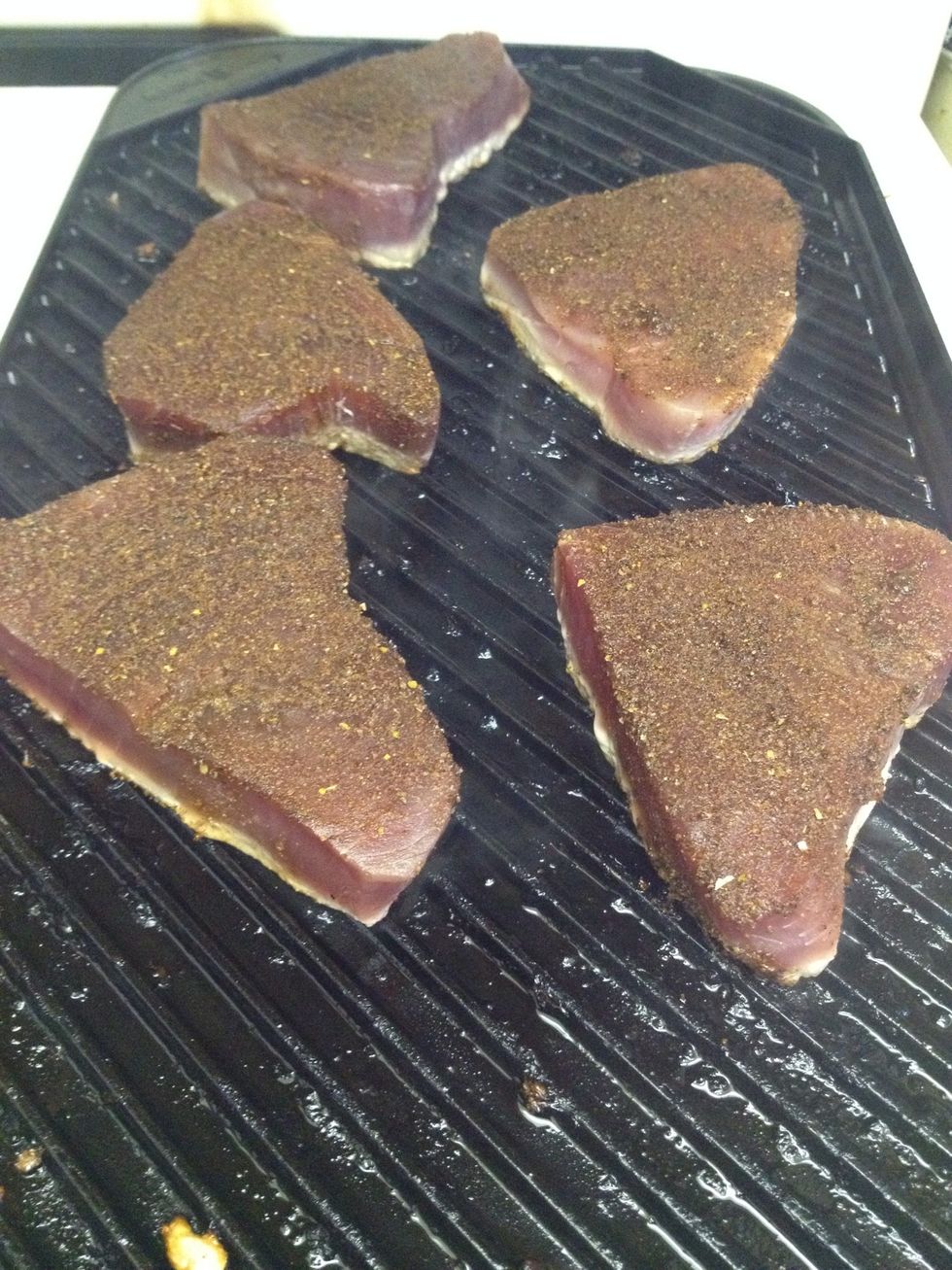 Place the steaks on hot grill.