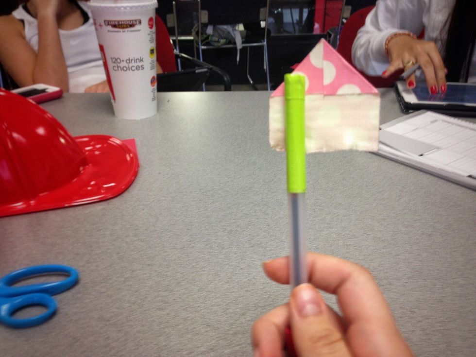 Place the sticky part of the tape onto the end of your pen.