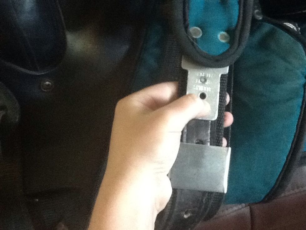 Place the stirrup end into holes 9 and 10 in this case. Make sure the metal prongs are fully through the leather and slide the slide back up.
