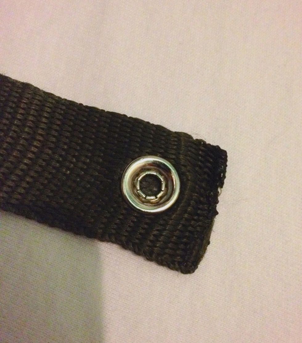 Place the strap around your belt and torch to find the right position for the female press stud. This should be attached on the opposite side of the strap.