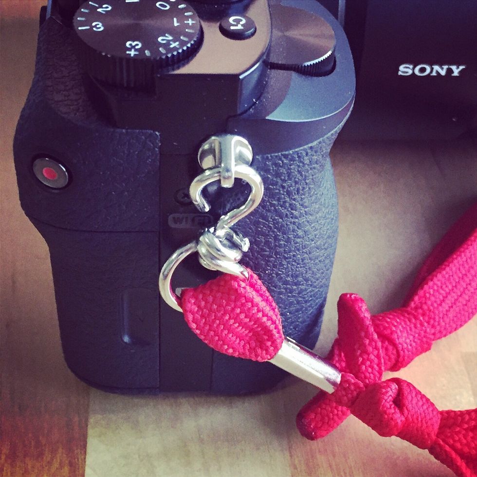 Place the strap ring onto the camera strap ring and tighten with the pliers.