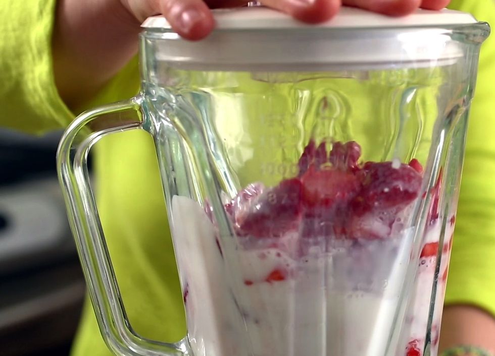 Place the strawberries into a blender. Add 1\u00bd cups of cold milk and 2 tablespoons of honey. Blend it for about 30 seconds, until the strawberries are crushed and well mixed with the milk.
