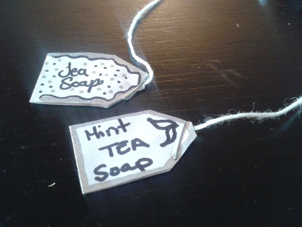 Place the string between the folded ends of the cut-out, and staple in place (you may instead opt to use glue to seal the cut-out's shut around the string).