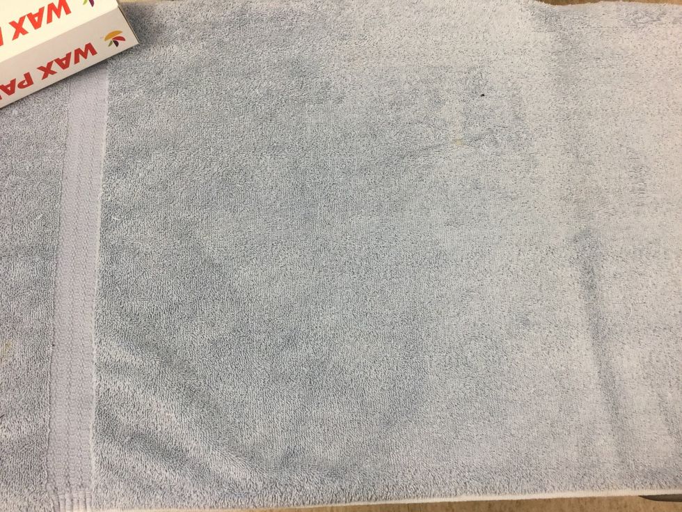 Place the thick towel on the table