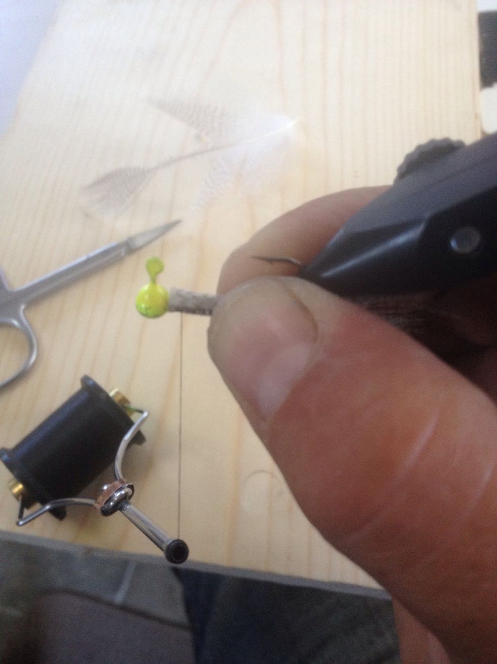 Place the thread on the shank and run your bobbin of thread down towards the tail and back to the head. I usually go about the middle between the hook and head.
