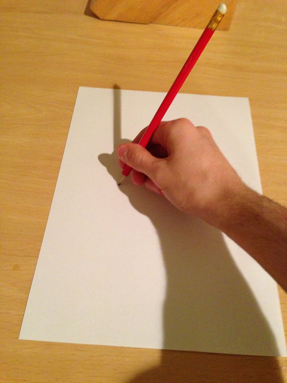Place the tip of the pencil on the pencil on the paper loosely so that it will draw, but not stop the paper from moving.