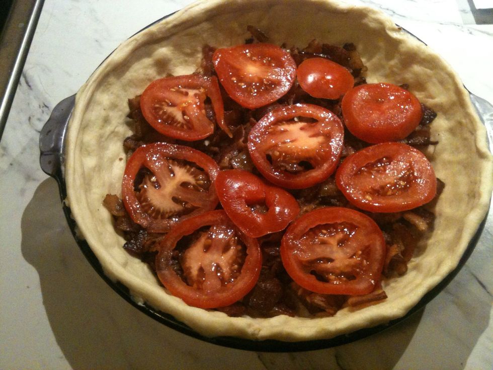 Place the tomato slices on top of the bacon.