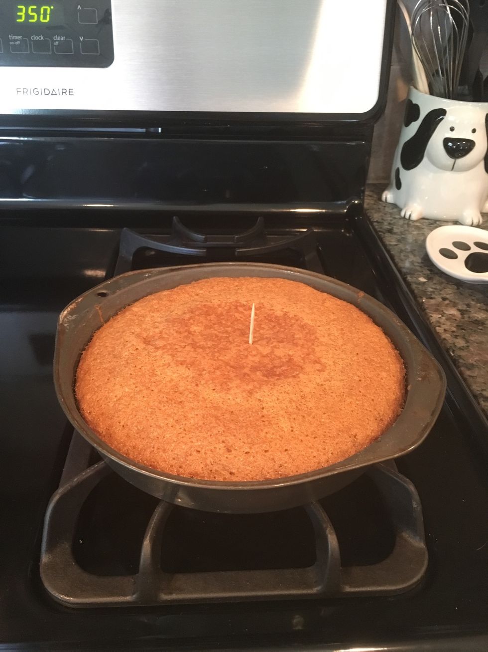 Place the toothpick in the center of the cake and then remove it. If the toothpick comes out clean then the cake is done baking. If the toothpick is not clean, then place it back in the oven.