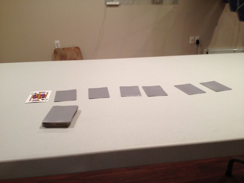 Place the top card of the deck face up and six cards next to it
