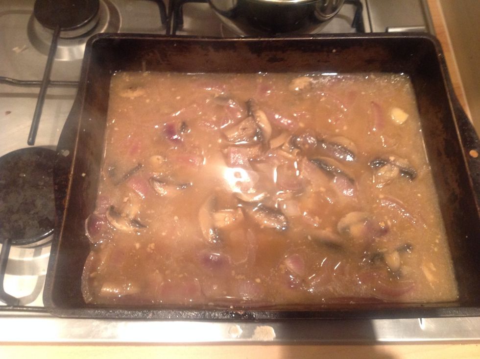 Place the tray with the veg, cider and juices onto the hob on a medium heat and bring to a gentle boil