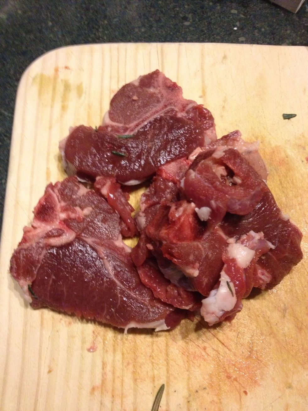 Place the trimmed lamb in the pot but keep the bones on the meat