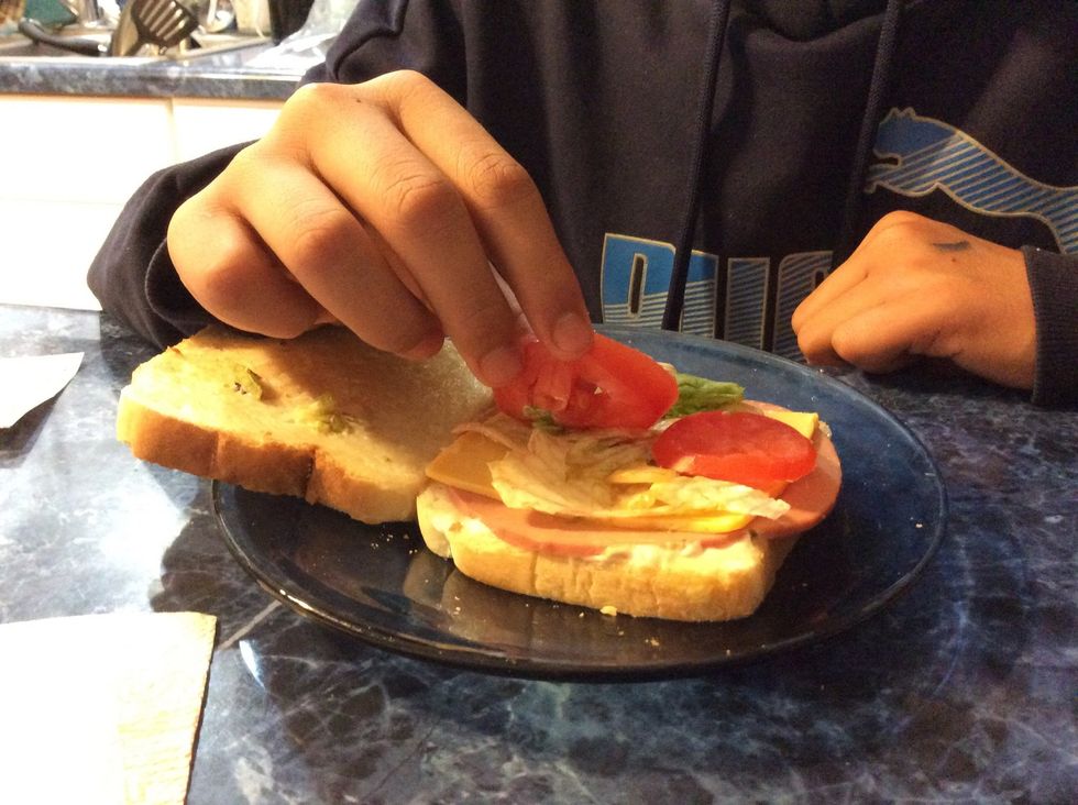 Place the two pieces of tomatoes on the lettuce.