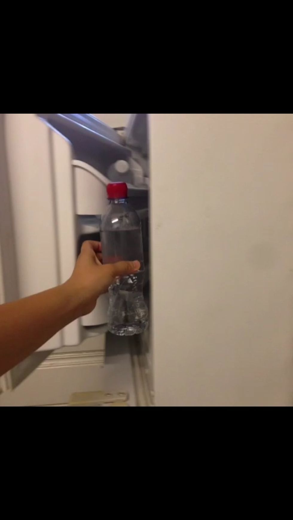 Place the water bottle in the freezer overnight.