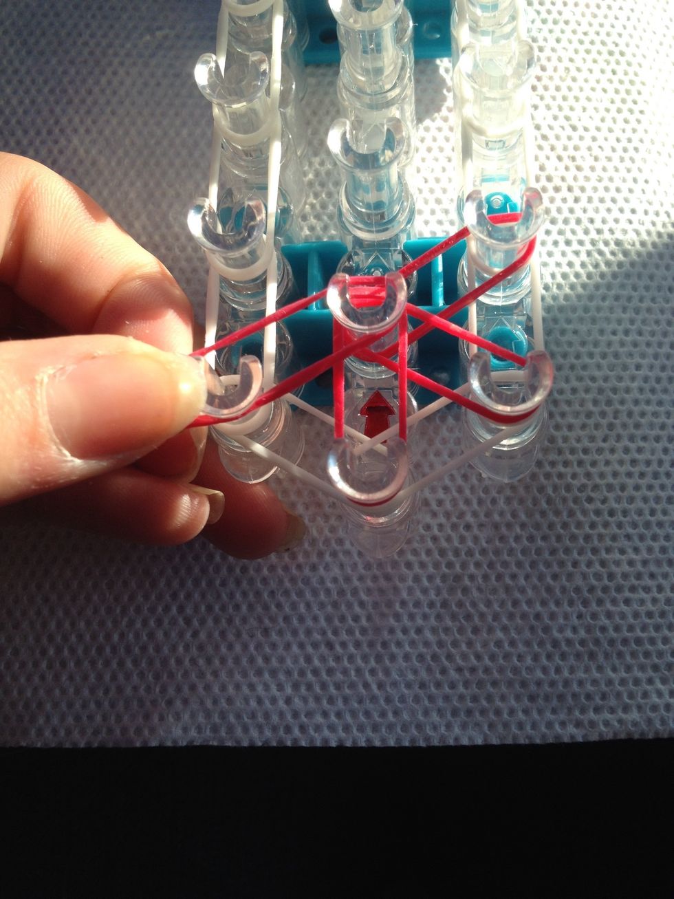 Place them clockwise, an push them down in the center as you go so it is not bunched up on he middle peg.