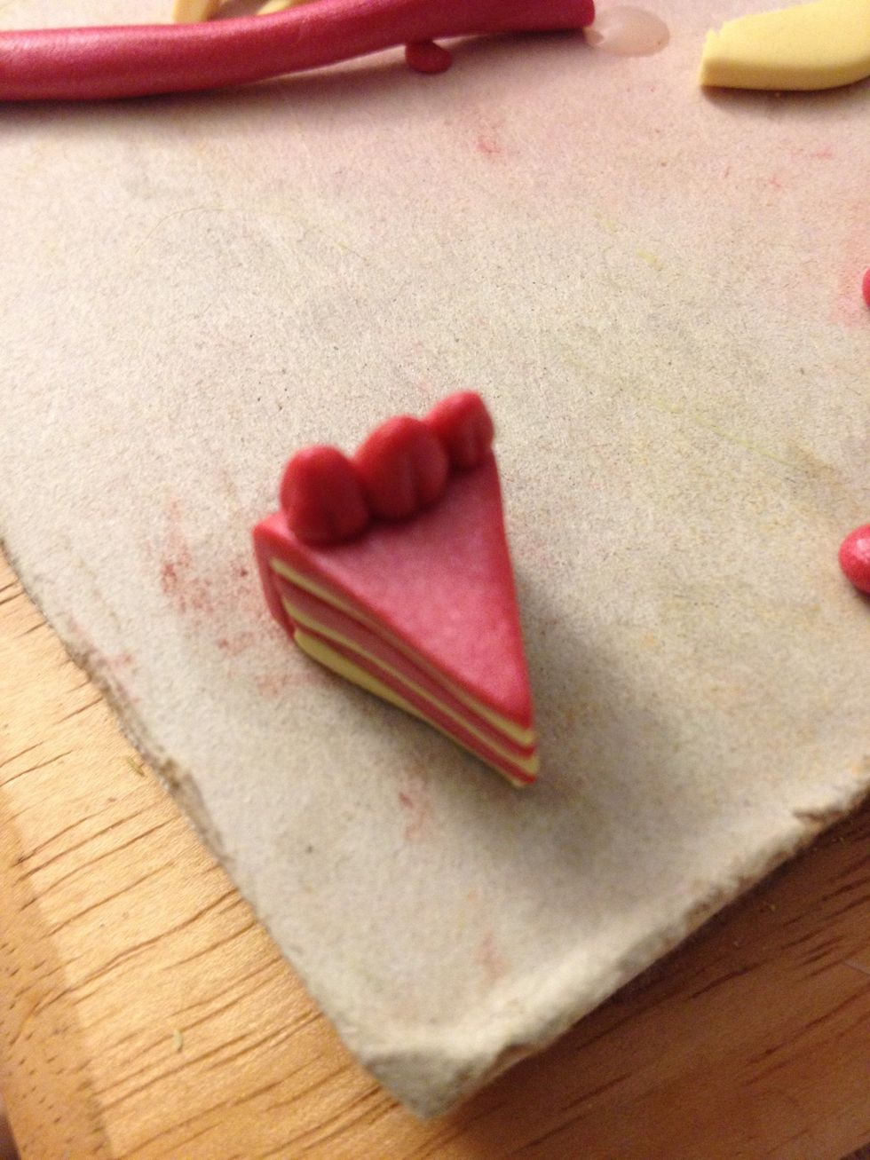 Place them on top of the cake and use the needle tool to add line details to each.