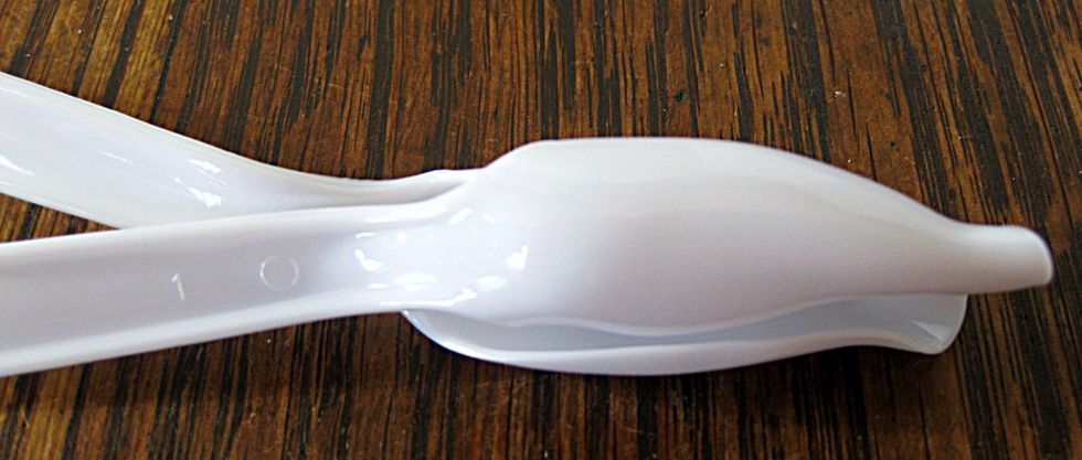 Place them together and melt the handles just under the buds. Keep an eye on this so that you don't get too close to the flame or overheat and cause blackening of the plastic.