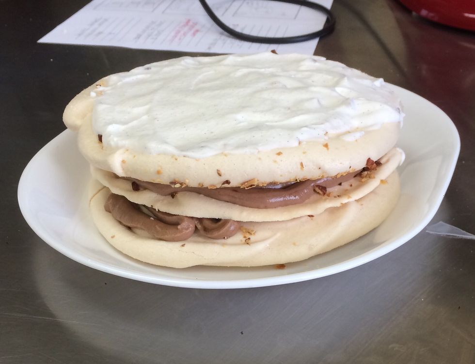 Place third meringue layer on top and cover with whipping cream.