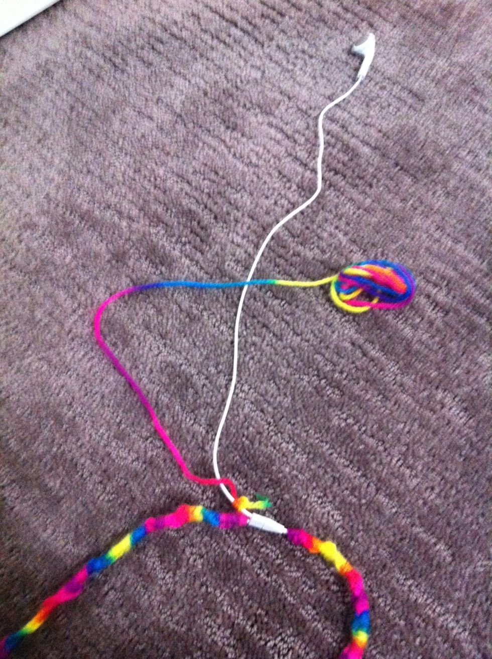 Place thread over the cord in a backward 4 shape