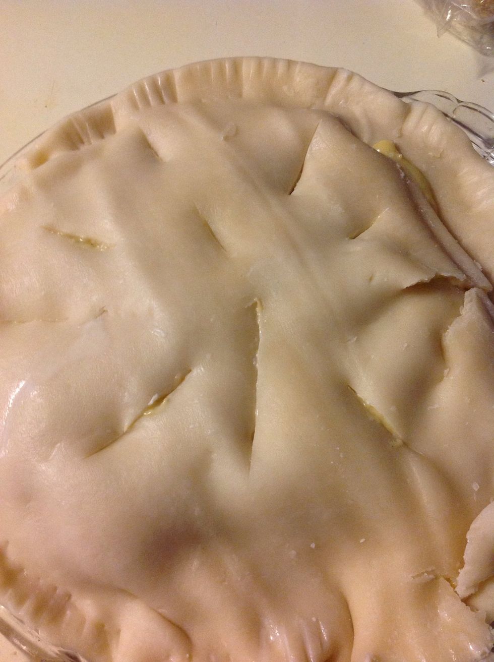 Place top crust over filling, and fold under edge, score edge of crust with a fork. Slice vents in top crust. Place in pre-heated oven set at 425. Bake until crust is golden brown.