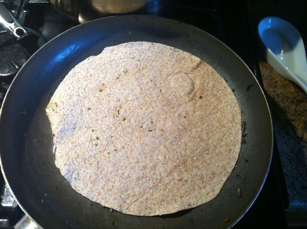 Place tortilla on pan, turn heat to low.