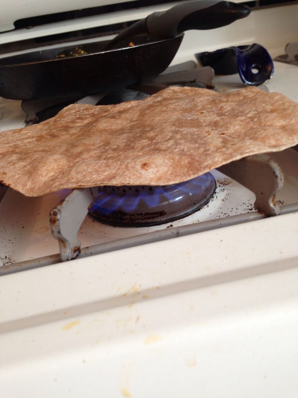 Place tortilla on stovetop. Be very careful not to burn yourself. Always lower heat when prepared to take tortilla off stove.