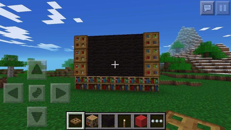 Place trap doors on the side for speakers and black wool for the screen