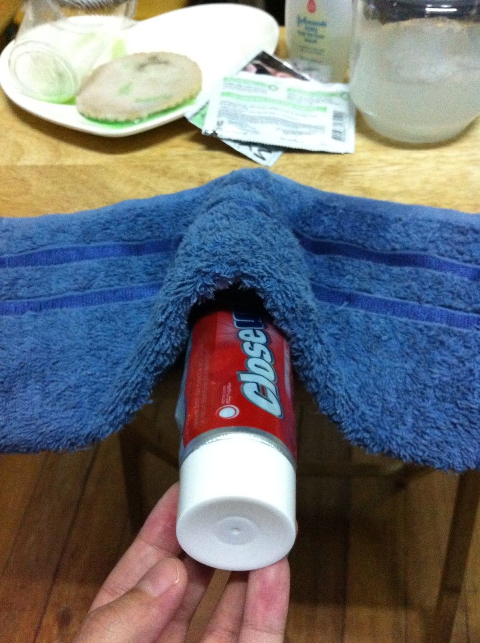 Place tube underneath the dish towel.