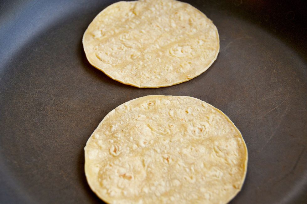 Place two corn tortillas in a pan over high heat.  The goal is to crisp them up a bit.  It's a trick I learned from a place called The TJ Oyster Bar - they make the best tacos in San Diego!