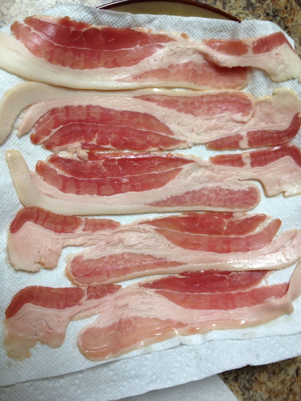 Place two layers of paper towel on a microwave safe plate. Lay out bacon on paper towels.