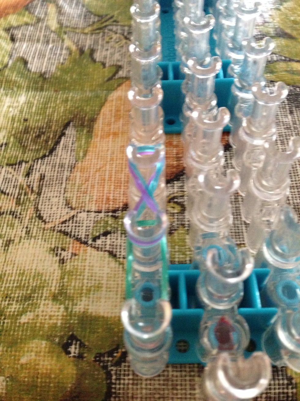 Place two of each color band on this peg in a figure eight way