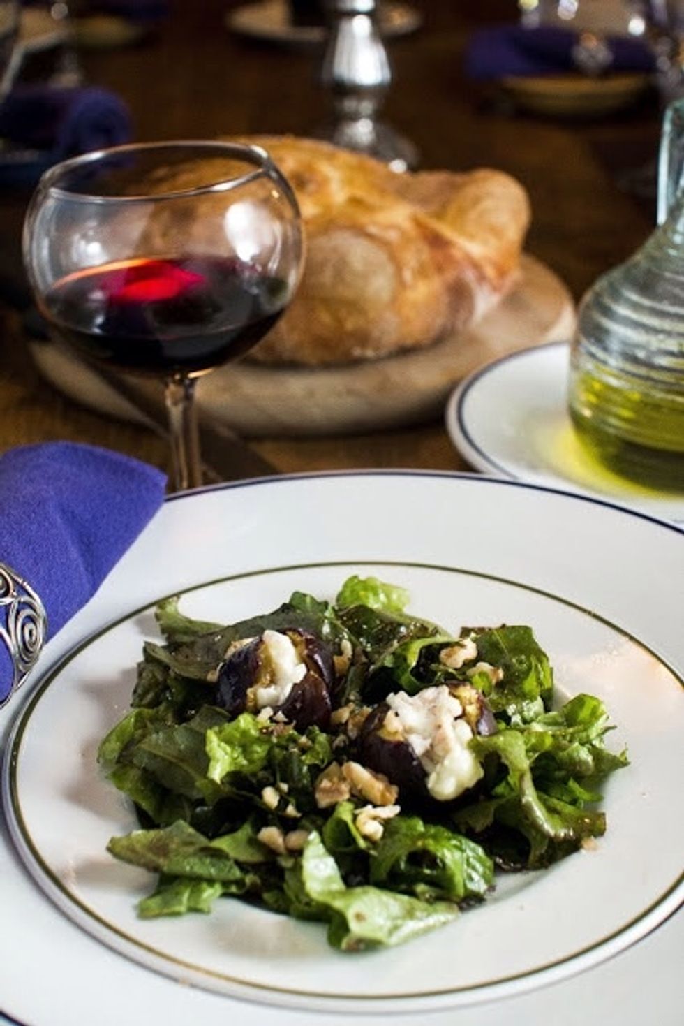 Place two stuffed figs onto each bed of greens. Sprinkle the chopped walnuts onto each plate, and serve them up.