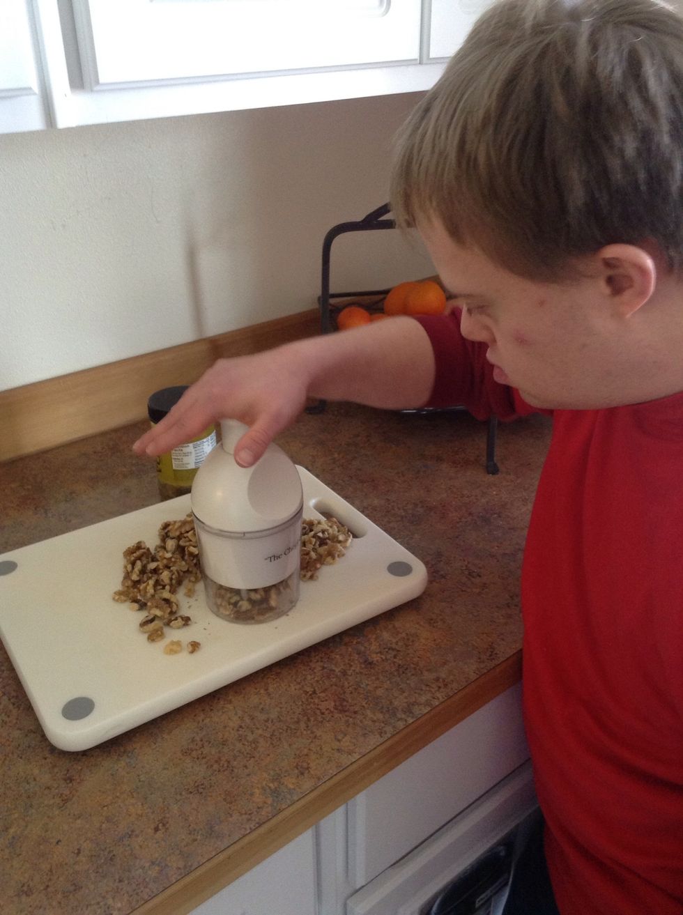 Place walnuts on chopping board then place quick chop over nuts. Push the top done to coarsely chop nuts