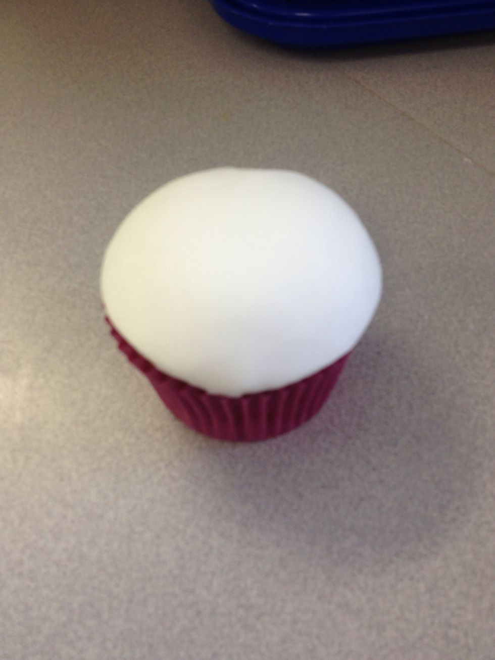 Place white fondant on the top of the cupcake