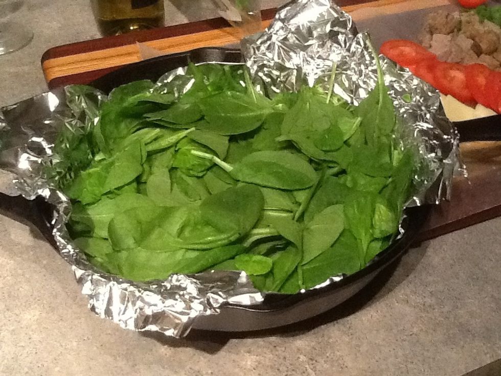 Place you spinach in the cast iron skillet