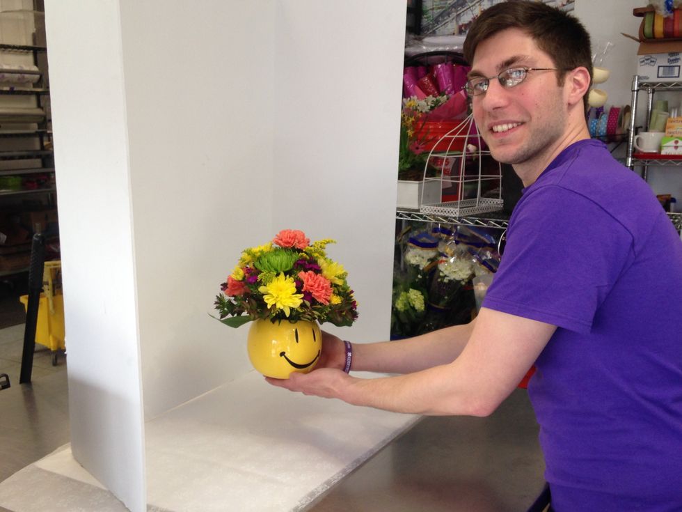 Place your arrangement on your set. Ensure the arrangement is well lit to get the best pictures. Natural light works best or lighting the arrangement above and to the side.