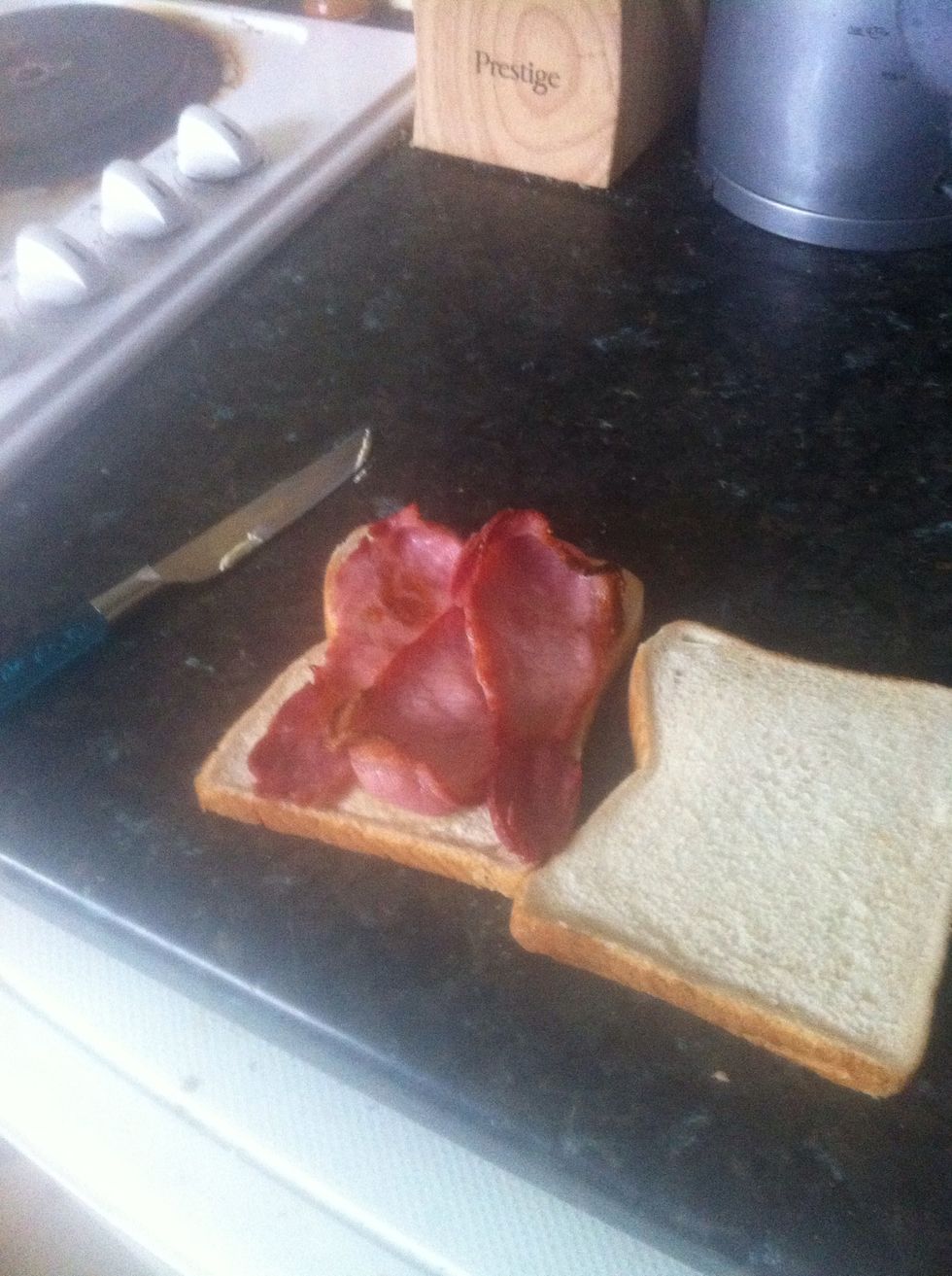 Place your bacon on the buttered piece of bread