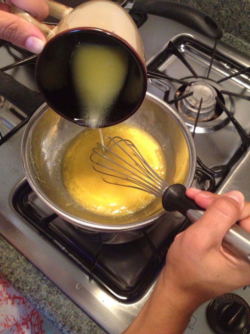 Place your butter/lemon bowl on top of the SIMMERING pot. Whisk in the melted butter. DO NO STOP WHISKING! Or it will turn into scrambled eggs.