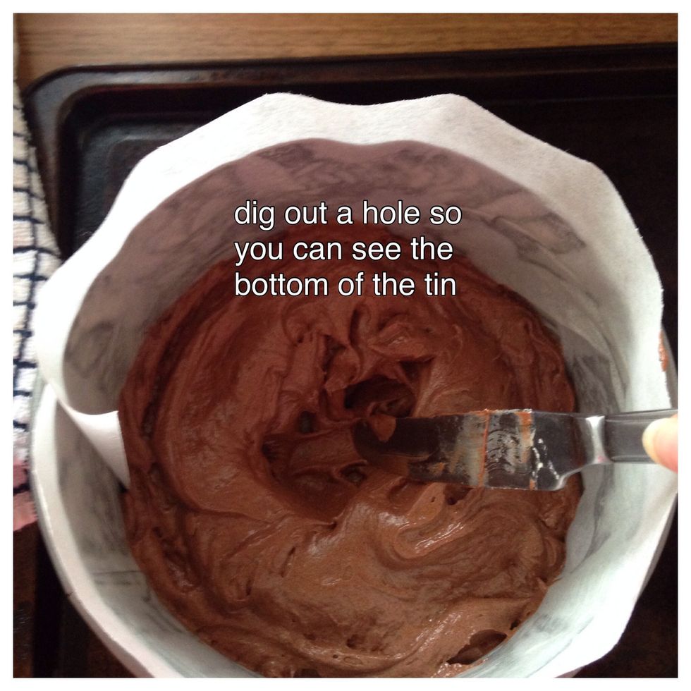 Place your cake batter into the tin. Tap it on the work surface twice to get rid of the air bubbles. Dig out the middle of the batter. This prevents your Madeira forming that big cracked dome.