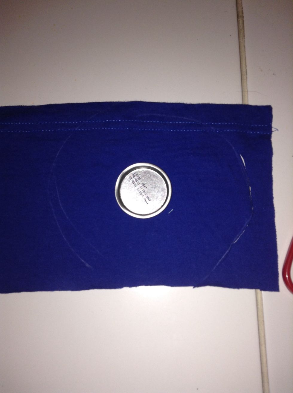 Place your cap on the centre of the fabric and draw a circle around it roughly two inches away.