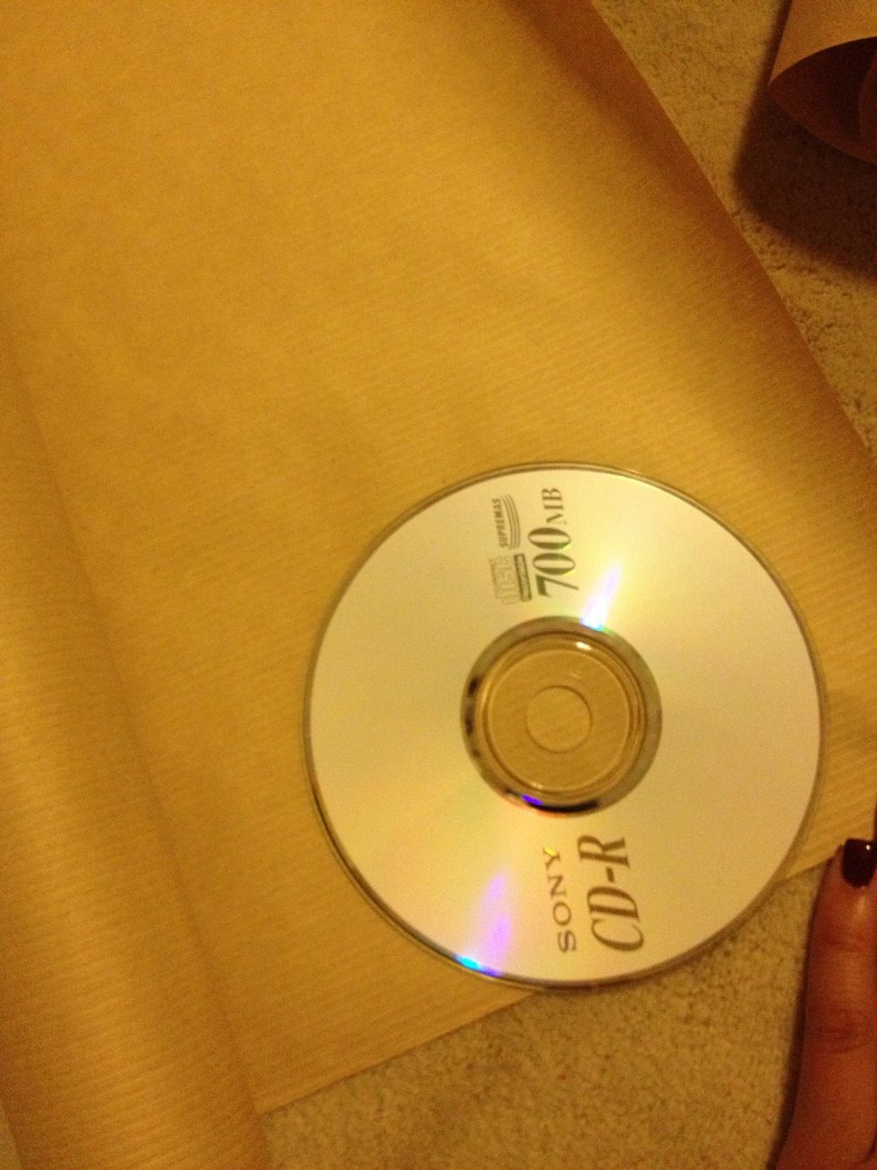 Place your CD on the paper and try to gage how much paper to cut