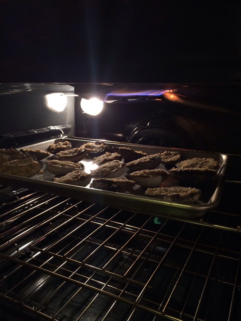 Place your clams in the pre heated oven & cook for about 15-20 min. or until the tops are  browned. Shouldn't take long, just keep watch to not over cook them or they will dry out & that is a nono.