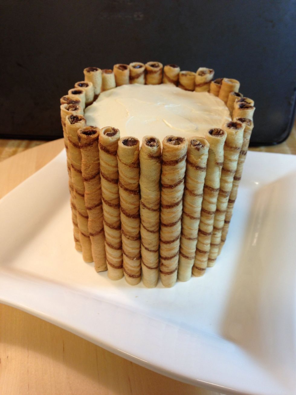 Place your cookies all around the cake. Press gently to make sure they stick to the frosting. You can serve it like this, or.....