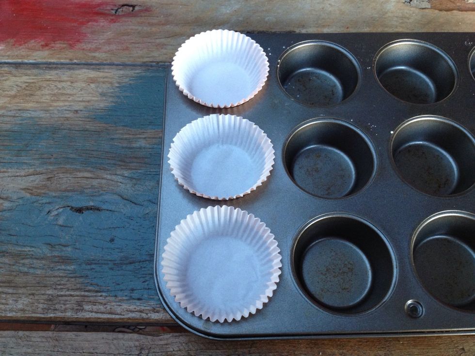 Place your cupcake cases in the baking tray. You can use any sort of cases you want. I used white and pastel pink because that's all I had and I'm going to paint over them so I wanted light colours.