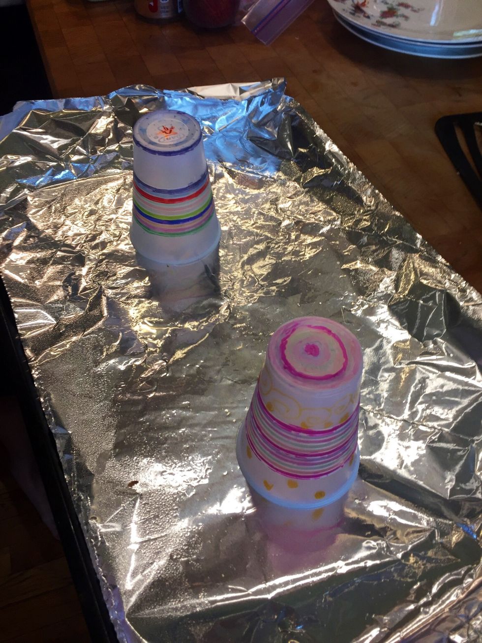 Place your cups on a foil lined cookie sheet sprayed with Pam. Put in the oven at 350 degrees F and take them out once they are flat.